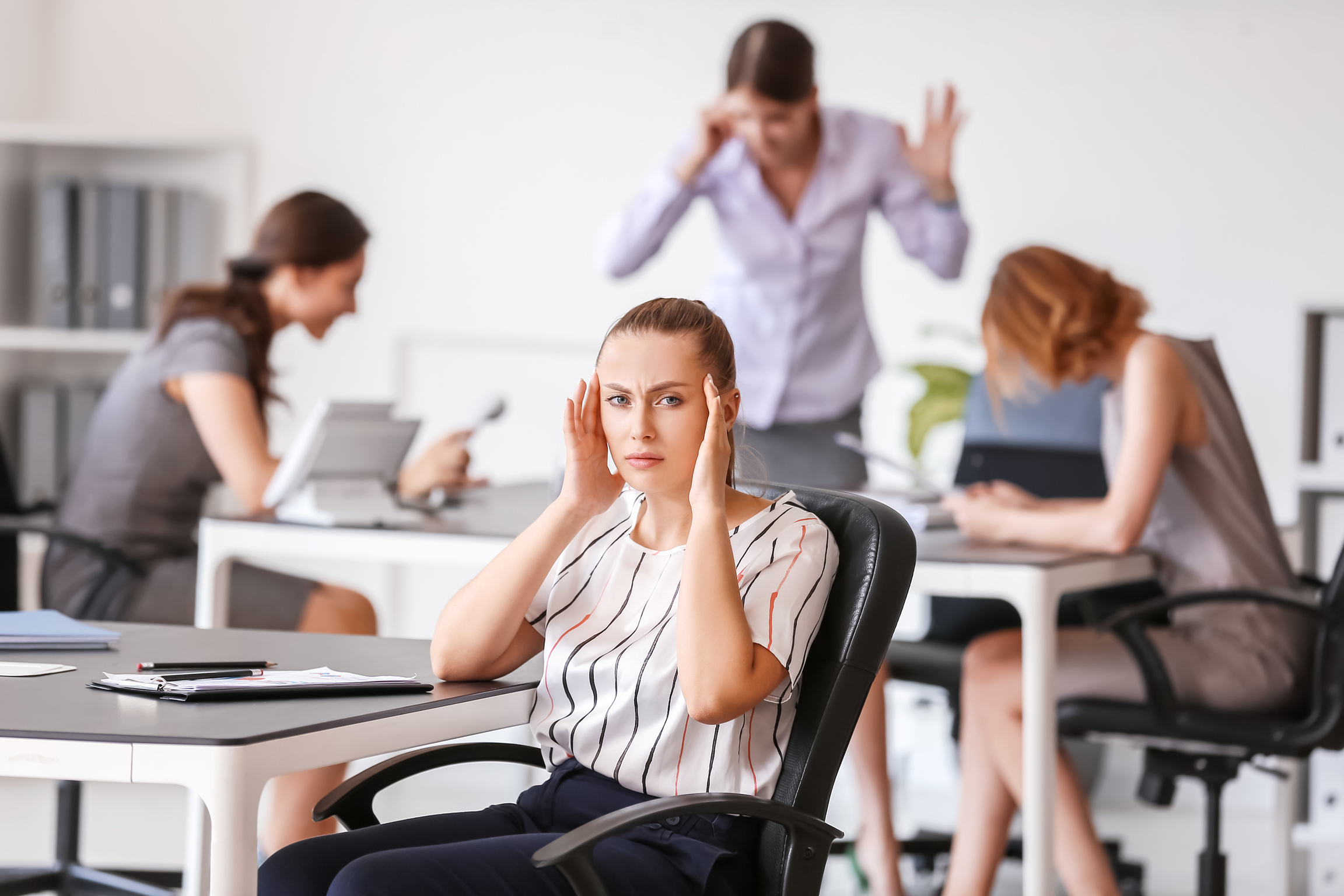 Stressed Woman with Headache and Noisy People in Office